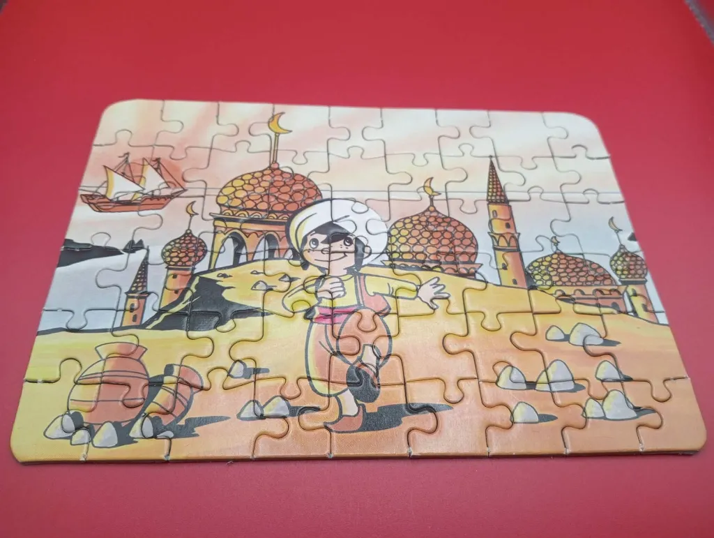 Mini-puzzle Sindbad – FX Schmid – 1978 – jeu de patience miniature en carton – vintage – boîte rectangulaire illustrée montrant Sindbad devant des palais orientaux avec logo trèfle rouge FX Schmid et mention Made in West Germany