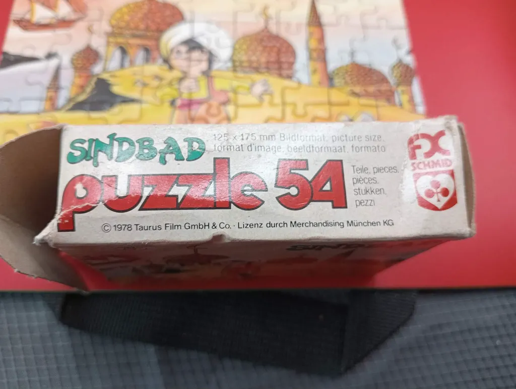 Mini-puzzle Sindbad – FX Schmid – 1978 – jeu de patience miniature en carton – vintage – boîte rectangulaire illustrée montrant Sindbad devant des palais orientaux avec logo trèfle rouge FX Schmid et mention Made in West Germany
