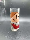 Verre transparent portrait de Grincheux Disney, décor marron rouge et blanc avec nuages et éclairs, logo Disneyland Paris au revers