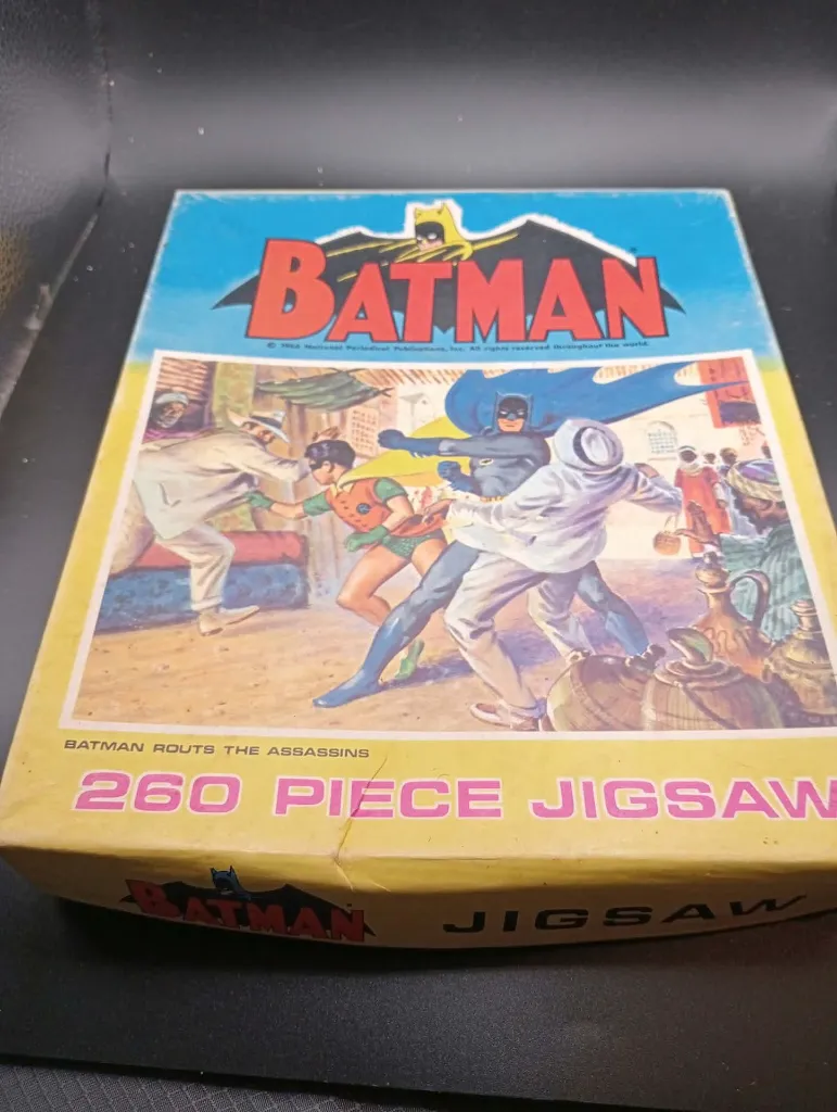 Vintage 1966 Batman Routs the Assassins 260 piece jigsaw puzzle, complete and assembled, showing Batman and Robin fighting attackers in a marketplace