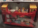 1986 LEGO DUPLO 2770 play house stored in a red and silver carrying case with transparent front, figures, kitchen, bathroom, beds and furniture