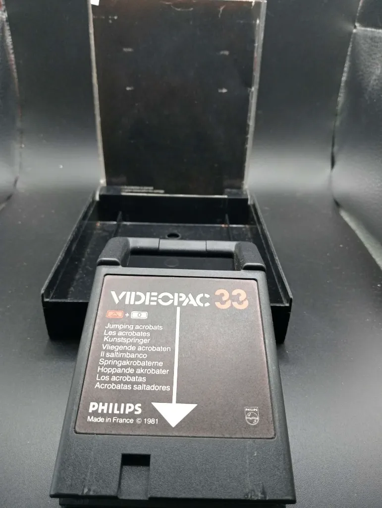 1981 Philips Videopac 33 Jumping Acrobats game for G7000, black Made in France cartridge and transparent case cracked along the lower edge