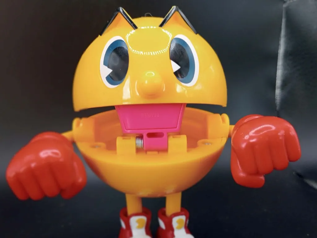 Large yellow Bandai Pac-Man Ghost Grabbin’ Pac figure with red gloves, red and white shoes, opening mouth and long spring-loaded pink tongue