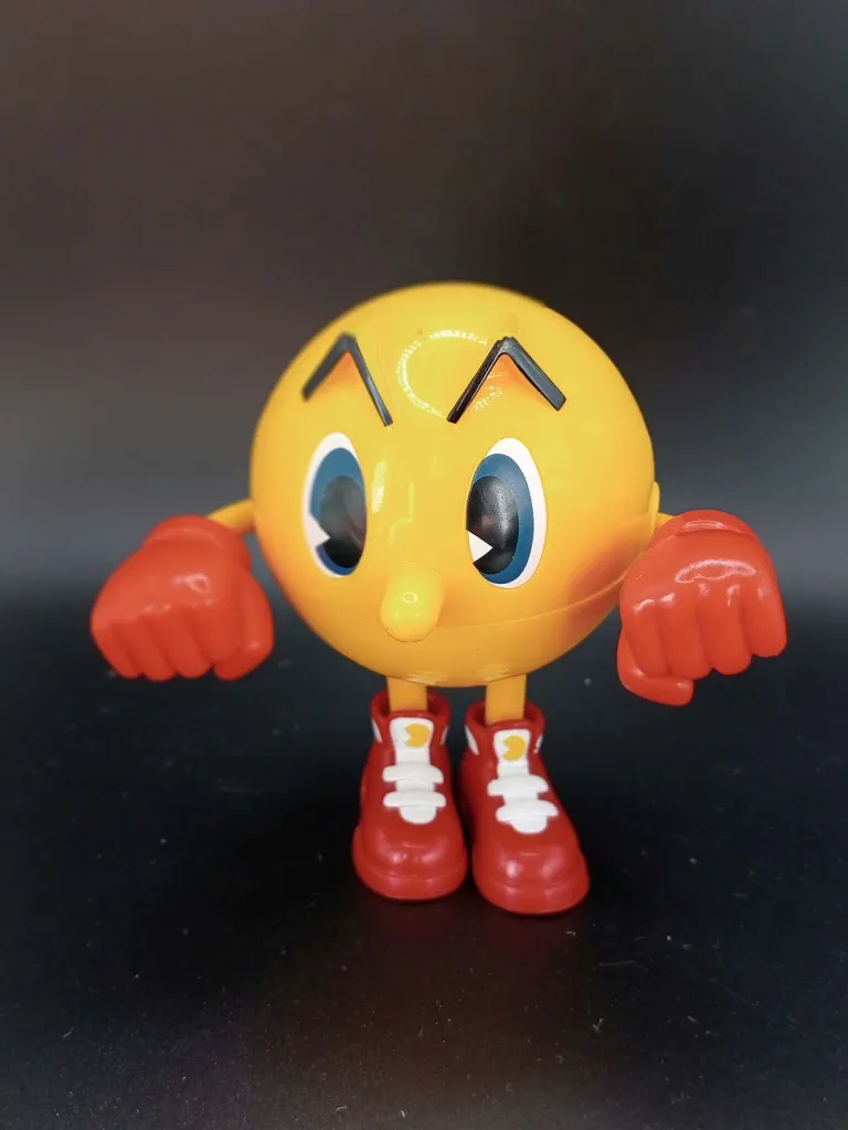 Grande figurine jaune Pac-Man Ghost Grabbin’ Pac de Bandai avec gants rouges, chaussures rouges et blanches, bouche articulée et longue langue rose montée sur ressort