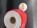 Red vintage Roughneck thermos with Snoopy and Woodstock, white stopper with orange flip tap and missing outer cup