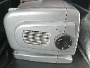 Silver portable TV200 mini television with 5.5-inch black and white CRT screen, AM FM radio, side tuning dials, telescopic antenna and carrying handle