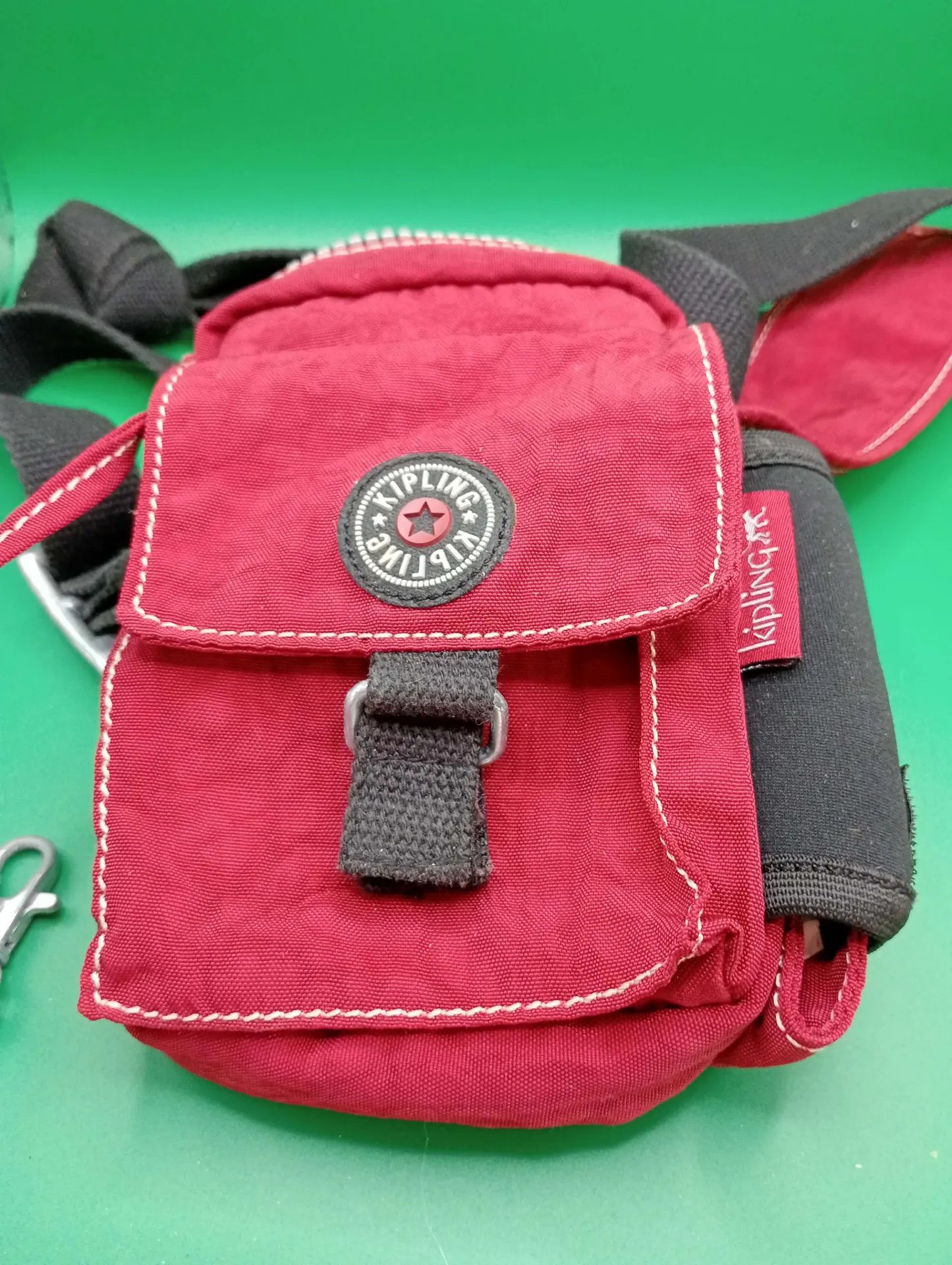 Red Kipling crossbody bag with monkey keychain